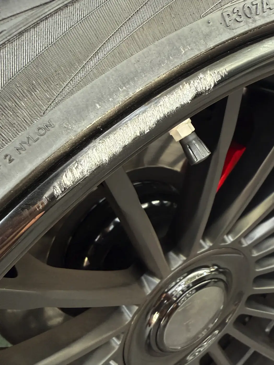 Mobile Wheel Repair Anaheim Rolls-Royce wheel with curb rash before repair